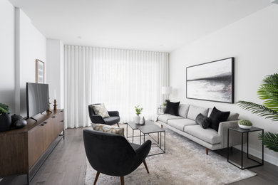 Mid-century modern living room photo in Montreal with gray walls