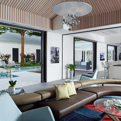 Trendy open concept living room photo in Miami with white walls
