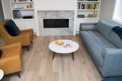 Living room - mid-sized 1950s light wood floor and brown floor living room idea in Toronto with gray walls, a standard fireplace and a tile fireplace
