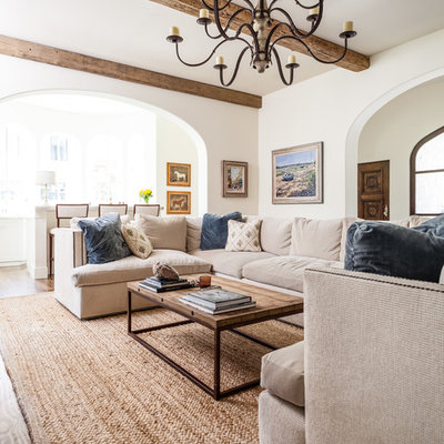 Example of a tuscan living room design in Dallas with white walls