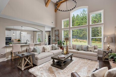 Example of a transitional open concept dark wood floor and brown floor living room design in Atlanta with gray walls