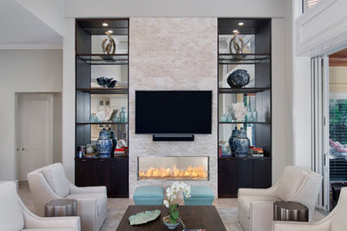 マイアミにあるトランジショナルスタイルのおしゃれなLDK (グレーの壁、磁器タイルの床、横長型暖炉、石材の暖炉まわり、壁掛け型テレビ) の写真