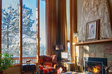 This is an example of a large rustic formal living room curtain in Denver with beige walls, a standard fireplace and a stone fireplace surround.