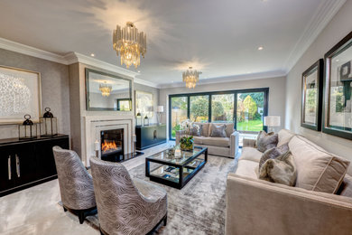 Inspiration for a large contemporary formal enclosed living room in Buckinghamshire with carpet, a standard fireplace, a stone fireplace surround, no tv and beige floors.