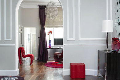 This is an example of a contemporary enclosed living room curtain in London with grey walls and no tv.