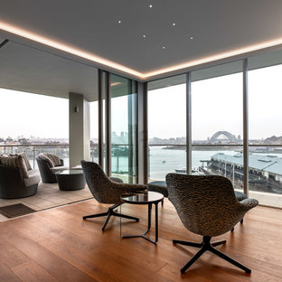 Design ideas for a contemporary living room in Sydney with grey walls, medium hardwood floors and brown floor.