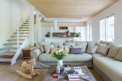 Example of a mid-sized beach style open concept light wood floor and beige floor living room design in Other with white walls
