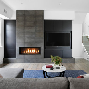 Design ideas for a contemporary formal enclosed living room in Melbourne with a stone fireplace surround, a built-in media wall, white walls, medium hardwood floors, a ribbon fireplace and beige floor.