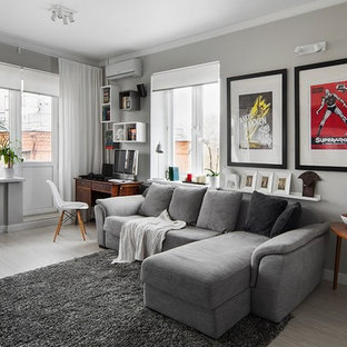 Photo of a classic enclosed living room in London with grey walls, light hardwood flooring and grey floors.