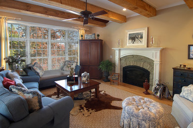 Großes, Abgetrenntes, Fernseherloses Klassisches Wohnzimmer mit beiger Wandfarbe, braunem Holzboden, Kamin, Kaminumrandung aus Stein und beigem Boden in Raleigh