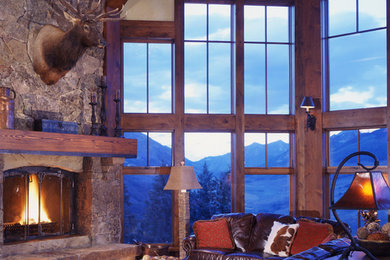 Large rustic living room in Denver with a stone fireplace surround, medium hardwood flooring and a corner fireplace.