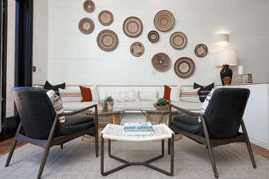 Example of a beach style terra-cotta tile living room design in San Diego with white walls and no fireplace