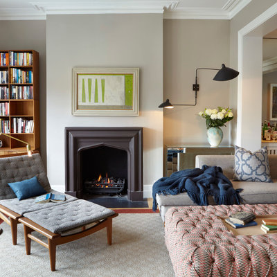 Example of a trendy living room design in London with gray walls and a standard fireplace