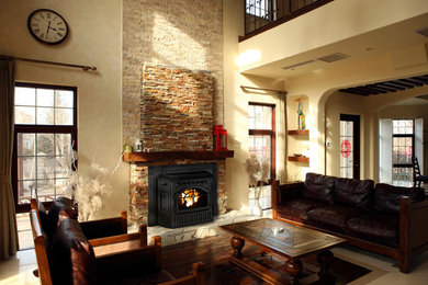 Example of a mid-sized classic enclosed carpeted and beige floor living room design in Seattle with beige walls, a standard fireplace, a stone fireplace and no tv