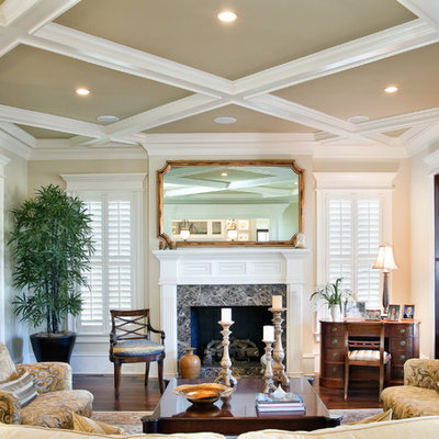 Example of a large classic formal and enclosed dark wood floor living room design in Charleston with beige walls, a standard fireplace and no tv