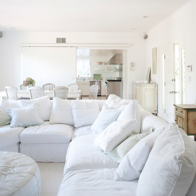 Example of a mid-sized cottage chic open concept living room design in Los Angeles with white walls