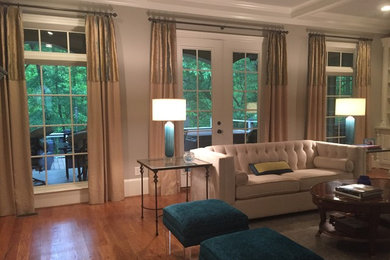 Photo of a classic open plan living room in Other with grey walls, medium hardwood flooring, a standard fireplace, a stone fireplace surround and brown floors.