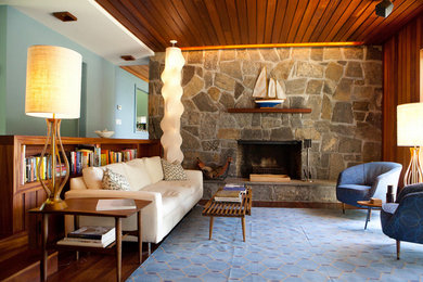 Inspiration for a coastal open concept living room remodel in New York with blue walls, a standard fireplace and a stone fireplace