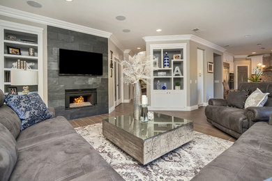 This is an example of a large contemporary open plan living room in Sacramento with grey walls, porcelain flooring, a standard fireplace, a stone fireplace surround and no tv.