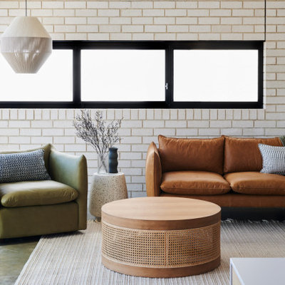Mid-sized trendy open concept concrete floor and gray floor living room photo in Adelaide with white walls and a wall-mounted tv