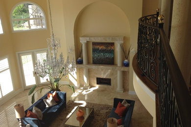 This is an example of a large classic formal open plan living room in San Diego with beige walls, a standard fireplace, a tiled fireplace surround and no tv.