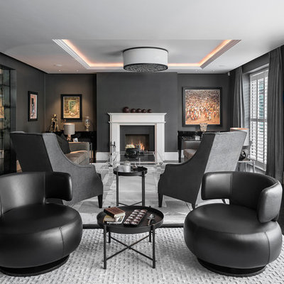 Example of a large trendy formal and enclosed dark wood floor and black floor living room design in Hampshire with black walls, a standard fireplace, a stone fireplace and no tv