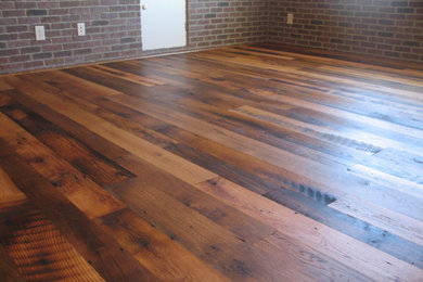 Small mountain style dark wood floor living room photo in Other with no fireplace