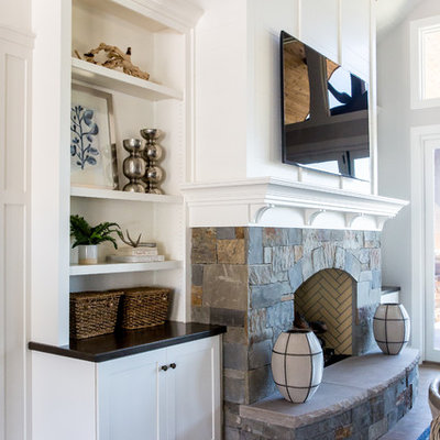 Large country open concept medium tone wood floor living room photo in Salt Lake City with white walls, a standard fireplace, a stone fireplace and a wall-mounted tv