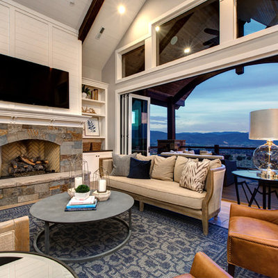 Large farmhouse open concept medium tone wood floor living room photo in Salt Lake City with white walls, a standard fireplace, a stone fireplace and a wall-mounted tv
