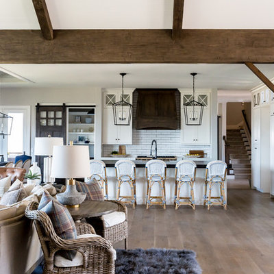 Large country open concept medium tone wood floor living room photo in Salt Lake City with white walls, a standard fireplace, a stone fireplace and a wall-mounted tv