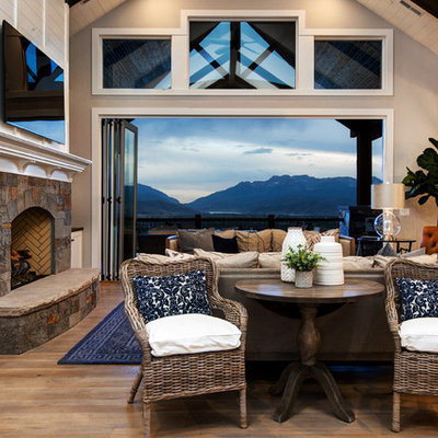 Inspiration for a large cottage open concept medium tone wood floor living room remodel in Salt Lake City with white walls, a stone fireplace, a wall-mounted tv and a standard fireplace