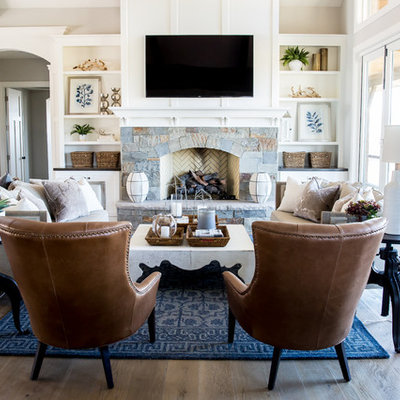 Living room - large country open concept medium tone wood floor living room idea in Salt Lake City with white walls, a standard fireplace, a stone fireplace and a wall-mounted tv