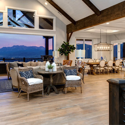 Inspiration for a large cottage open concept medium tone wood floor living room remodel in Salt Lake City with white walls, a standard fireplace, a stone fireplace and a wall-mounted tv