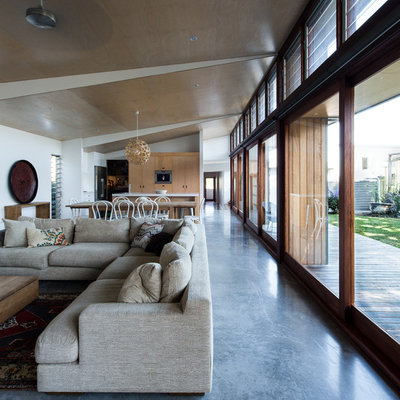 Large trendy open concept concrete floor and blue floor living room photo in Newcastle - Maitland