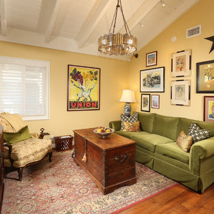 Living room - mid-sized eclectic formal and loft-style medium tone wood floor and brown floor living room idea in Los Angeles with yellow walls, no tv and no fireplace