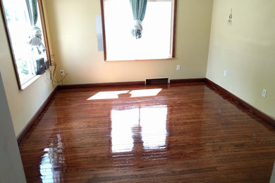 Example of a mid-sized classic enclosed dark wood floor and brown floor living room design in Other