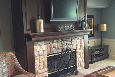 Mid-sized elegant open concept and formal carpeted and beige floor living room photo in Kansas City with gray walls, a standard fireplace, a stone fireplace and a wall-mounted tv