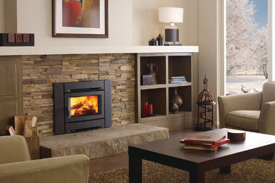 Example of a large trendy formal and open concept dark wood floor living room design in Calgary with a standard fireplace, a stone fireplace, beige walls and no tv