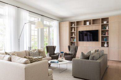 Example of a large transitional open concept light wood floor and brown floor living room design in Miami with white walls and a wall-mounted tv