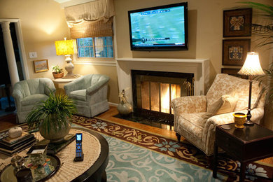Example of a large trendy enclosed carpeted living room design in Other with beige walls, a standard fireplace, a stone fireplace and a wall-mounted tv