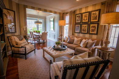 Immagine di un grande soggiorno chic aperto con sala formale, pareti beige, parquet scuro, nessun camino e pavimento marrone