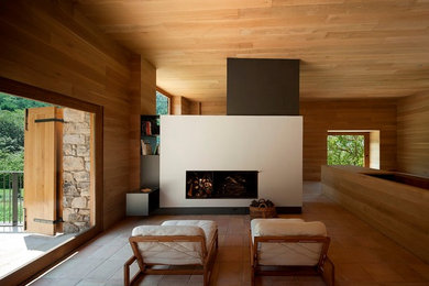 This is an example of a medium sized modern formal open plan living room in Barcelona with brown walls, terracotta flooring, a standard fireplace, no tv and a plastered fireplace surround.