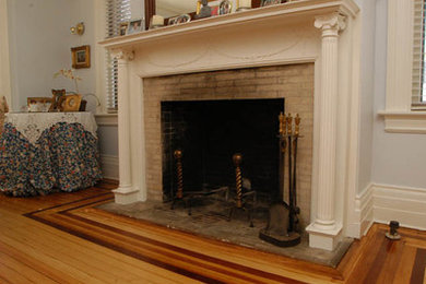 Mid-sized elegant formal and enclosed light wood floor living room photo in New York with blue walls, a standard fireplace and a stone fireplace