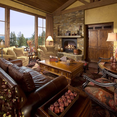 Huge tuscan formal and open concept medium tone wood floor living room photo in Phoenix with a standard fireplace, a stone fireplace, yellow walls and a concealed tv