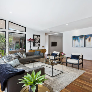 Design ideas for a mid-sized contemporary formal open concept living room in Melbourne with white walls, medium hardwood floors, no fireplace, no tv and brown floor.