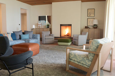 Inspiration for a large coastal formal and open concept carpeted living room remodel in Santa Barbara with beige walls, a standard fireplace, a plaster fireplace and no tv
