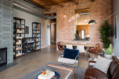 Living room - mid-sized industrial open concept dark wood floor living room idea in Chicago with gray walls and a standard fireplace