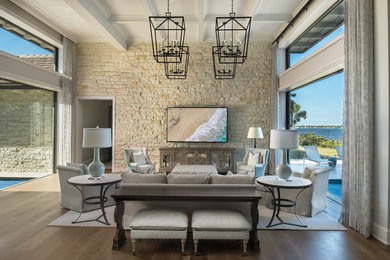 Example of a large transitional open concept medium tone wood floor and coffered ceiling living room design with gray walls and a wall-mounted tv