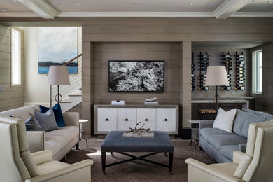 Ejemplo de salón con barra de bar abierto costero de tamaño medio con paredes beige, suelo de madera clara, televisor colgado en la pared y suelo beige