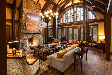 Living room - large eclectic open concept medium tone wood floor living room idea in Calgary with yellow walls, a stone fireplace and no tv
